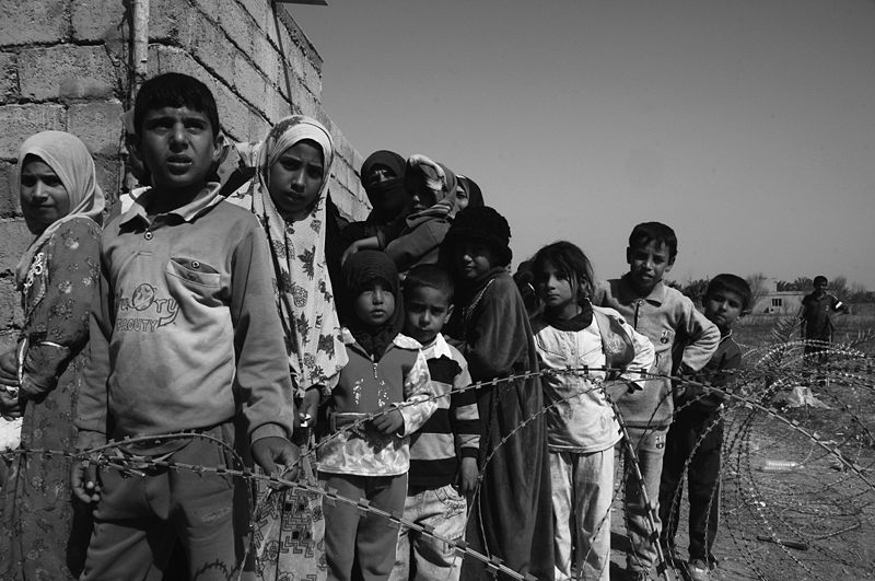 Refugees in line for supplies at a Minervan community